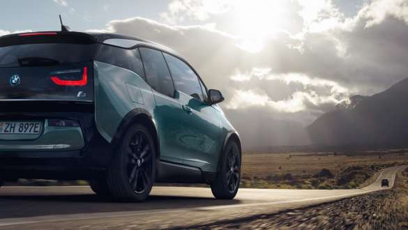 BMW i3 2018 set bagfra let drejet kørende på en landevej BMW i3 I01 2018 Jucaro Beige med detaljer i Frozen Grey metallic set bagfra let drejet kørende på en landevej