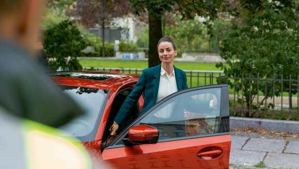 BMW vejhjælp og nødhjælp BMW vejhjælp og nødhjælp kvinde står ved den åbne dør til sin BMW