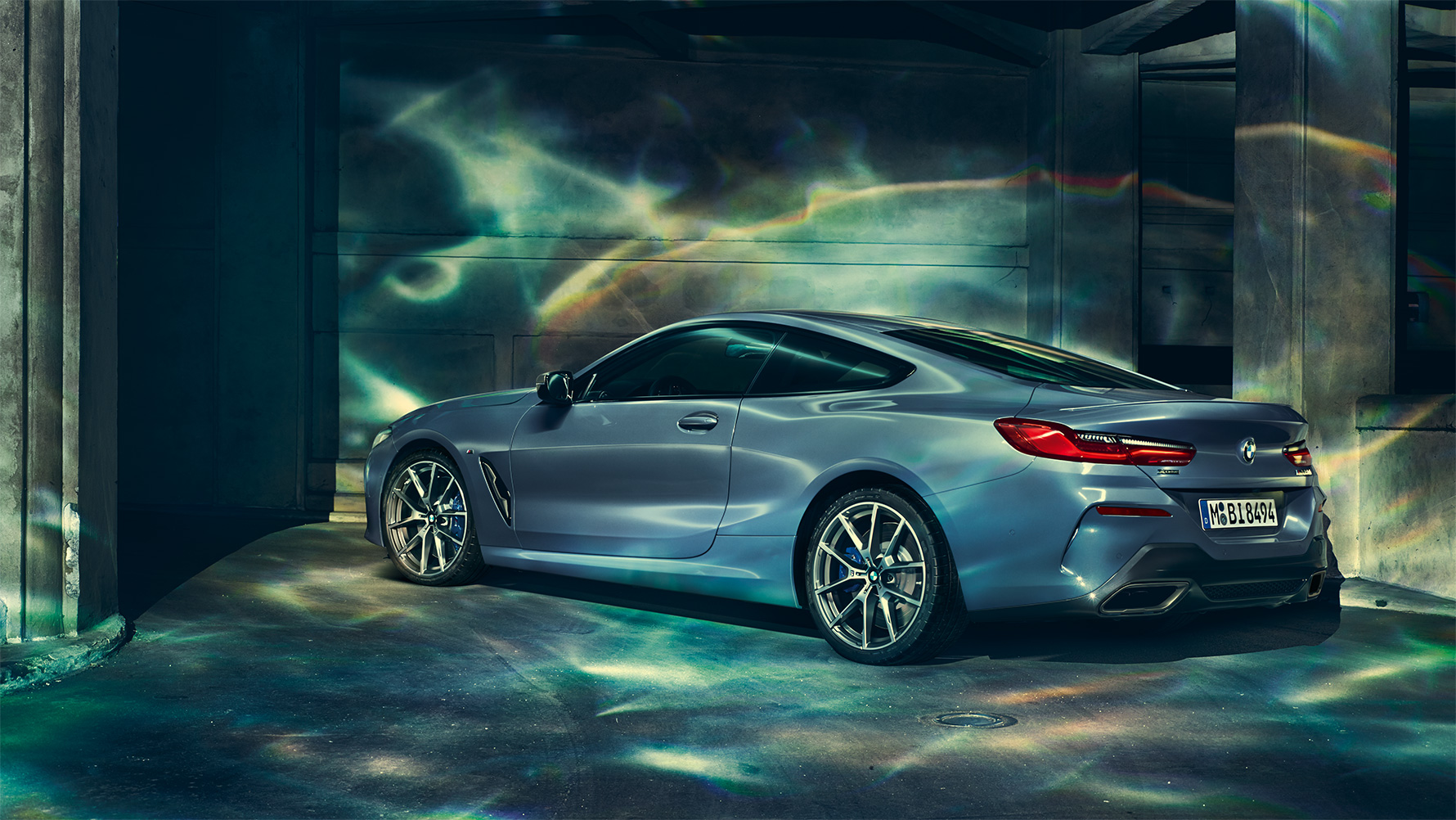 BMW 8-serie Coupé, trekvart bagparti Stillbillede med trekvart bagparti af BMW 8-serie Coupé i et storbymiljø om natten.