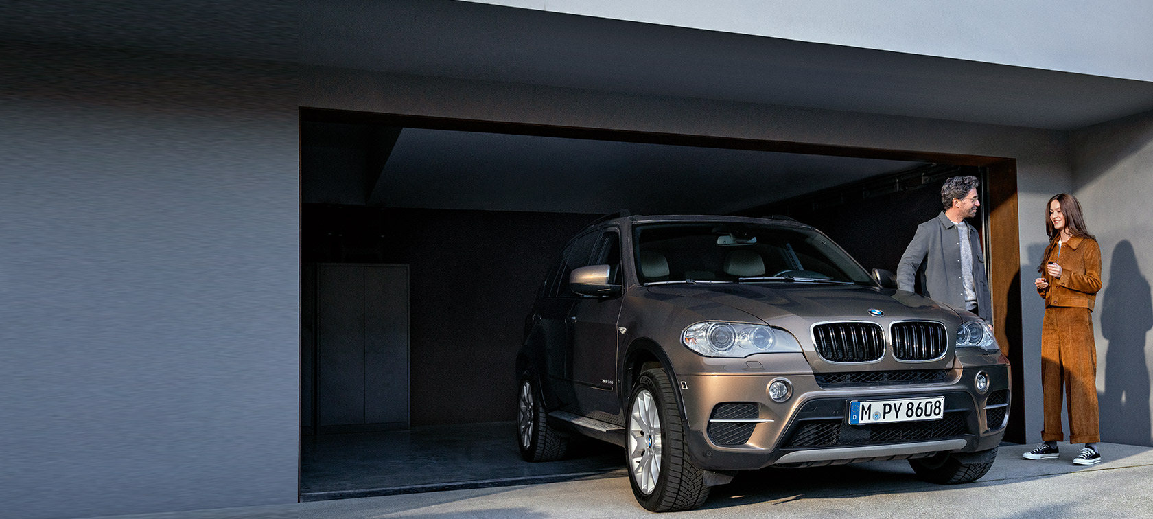 BMW Service 5+ BMW Service 5+ mand og kvinde foran en garage med BMW X5